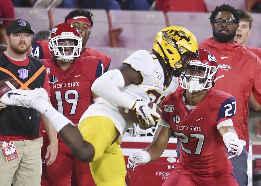 Minnesota's Kiondre Thomas, left, intercepts a pass intended for Fresno State's Zane Pope, right, during an NCAA college football game Saturday, Sept. 7, 2019, in Fresno, Calif. (Eric Paul Zamora/The Bee via AP)