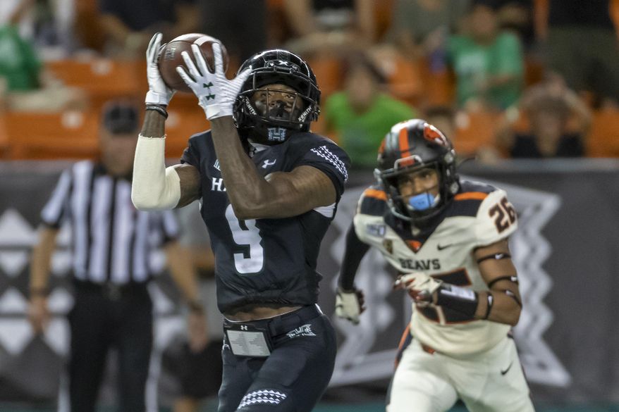 Hawaii wide receiver JoJo Ward (9) catches a pass for a touchdown while being defended by Oregon State defensive back Jojo Forest (26) during the second half of an NCAA college football game, Saturday, Sept. 7, 2019, in Honolulu. (AP Photo/Eugene Tanner)