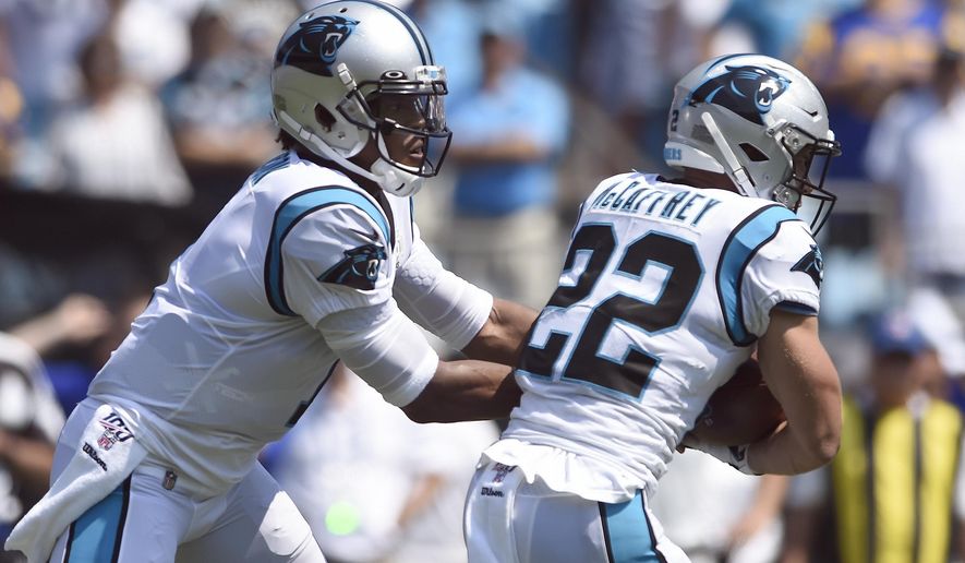 Carolina Panthers quarterback Cam Newton (1) hands off to running back Christian McCaffrey (22) during the first half an NFL football game against the Los Angeles Rams in Charlotte, N.C., Sunday, Sept. 8, 2019. (AP Photo/Mike McCarn)