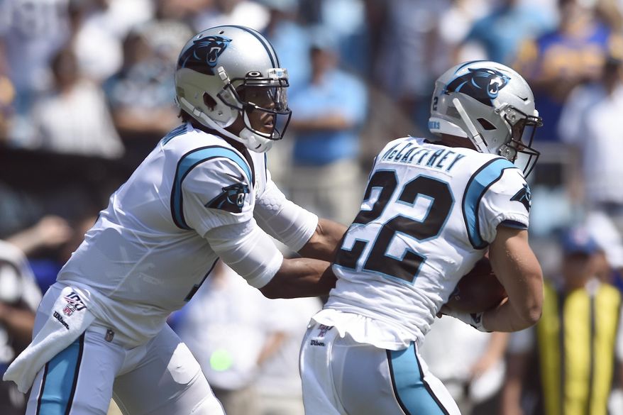 Carolina Panthers quarterback Cam Newton (1) hands off to running back Christian McCaffrey (22) during the first half an NFL football game against the Los Angeles Rams in Charlotte, N.C., Sunday, Sept. 8, 2019. (AP Photo/Mike McCarn)