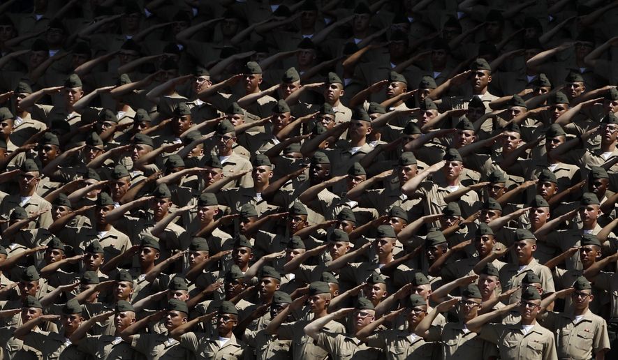 Recruits from Marine Corps Recruit Depot San Diego salute during the national anthem before a baseball game between the San Diego Padres and the Colorado Rockies, Sunday, Sept. 8, 2019, in San Diego. (AP Photo/Gregory Bull)