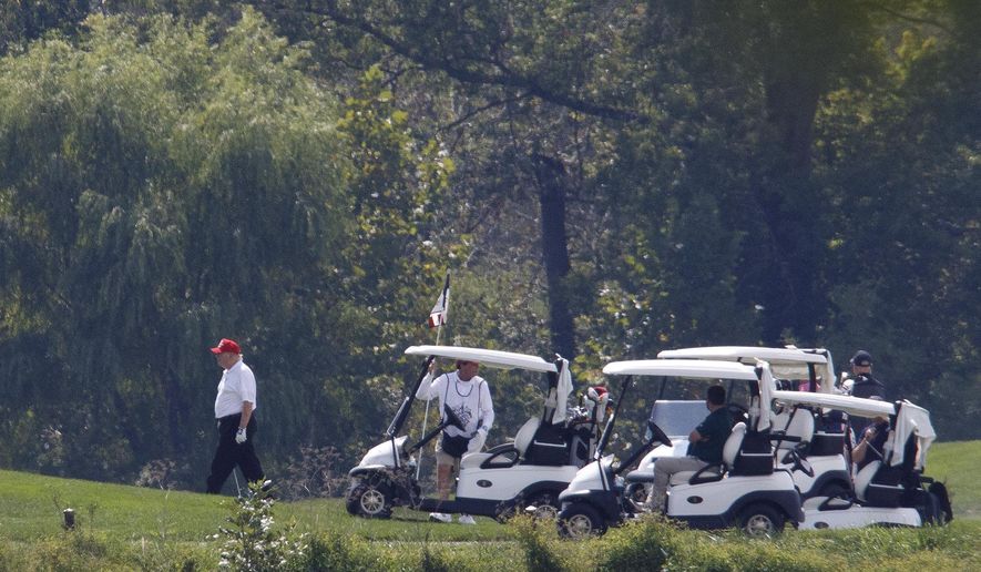 President Donald Trump, left, participates in a round of golf at the Trump National Golf Course in Sterling, Va., Sunday, Sept. 8, 2019. (AP Photo/ Tom Brenner)