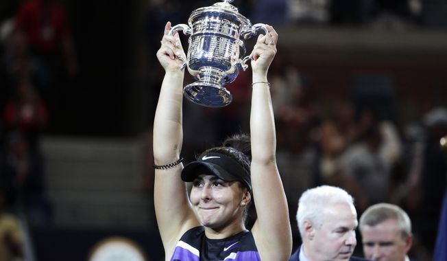 Bianca Andreescu, of Canada, holds up the championship trophy after defeating Serena Williams, of the United States, in the women&#x27;s singles final of the U.S. Open tennis championships Saturday, Sept. 7, 2019, in New York. (AP Photo/Adam Hunger)