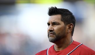 Washington Nationals manager Dave Martinez stands on the field before a baseball game against the Miami Marlins, Saturday, Aug. 31, 2019, in Washington. (AP Photo/Nick Wass)