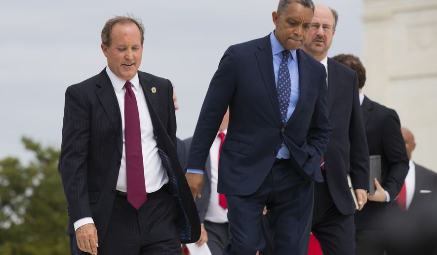 Texas Attorney General Ken Paxton, from left, District of Columbia Attorney General Karl Racine and Alaska Attorney General Kevin Clarkson, walk in front of the U.S. Supreme Court in Washington, Monday, Sept. 9, 2019. A bipartisan coalition of 48 states along with Puerto Rico and the District of Columbia said Monday it is investigating whether Google's search and advertising business is engaged in monopolistic behavior. It follows a Friday announcement of a similar multistate probe targeting Facebook. (AP Photo/Manuel Balce Ceneta)