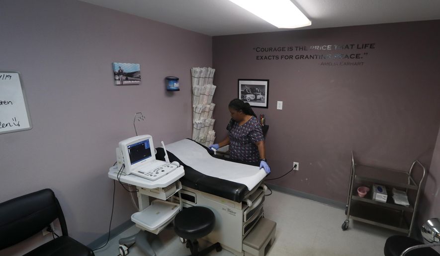 In this Sept. 4, 2019, file photo, an abortion clinic worker prepares the operating room in an abortion clinic in Fort Worth, Texas. On Feb. 27, 2020, the state of Wisconsin released statistics showing that the number of abortions performed in Wisconsin increased for a second straight year in 2018. The state's abortion right had declined the previous eight years. (AP Photo/Tony Gutierrez) **FILE**