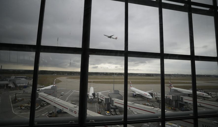 British Airways planes sit parked as a Turkish Airways plane takes off above them at Heathrow Airport in London, Monday, Sept. 9, 2019. British Airways says it has had to cancel almost all flights as a result of a pilots' 48-hour strike over pay. (AP Photo/Matt Dunham)