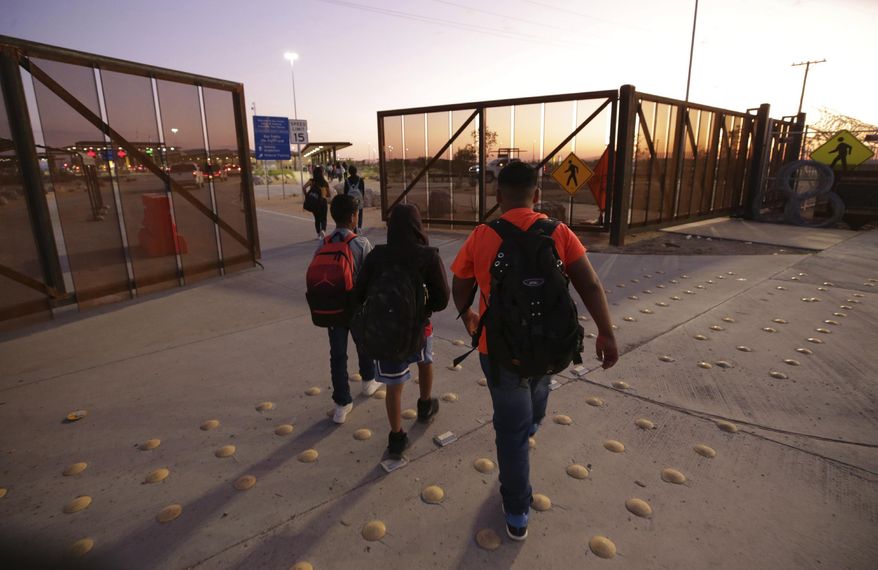 In this Wednesday, Sept. 4, 2019 photo, Students from Palomas, Mexico cross the border through the new port of entry between Palomas and Columbus, N.M. While debate continues to churn over President Donald Trump’s plans to build a $6 billion border wall _ sharp-tipped and painted black _ the tiny New Mexico village of Columbus is inaugurating a new port of entry designed to make travel and trade easier. It's the architectural equivalent of a welcome with open arms.  (Mark Lambie/The El Paso Times via AP)