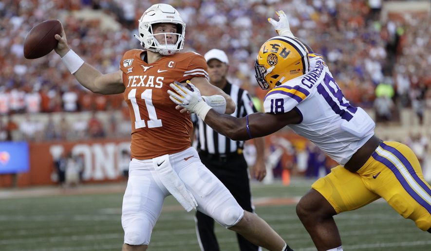 Texas quarterback Sam Ehlinger throws a pass as LSU linebacker K'Lavon Chaisson defends during the first half of an NCAA college football game Saturday, Sept. 7, 2019, in Austin, Texas. (AP Photo/Eric Gay)
