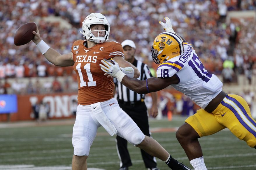 Texas quarterback Sam Ehlinger throws a pass as LSU linebacker K'Lavon Chaisson defends during the first half of an NCAA college football game Saturday, Sept. 7, 2019, in Austin, Texas. (AP Photo/Eric Gay)