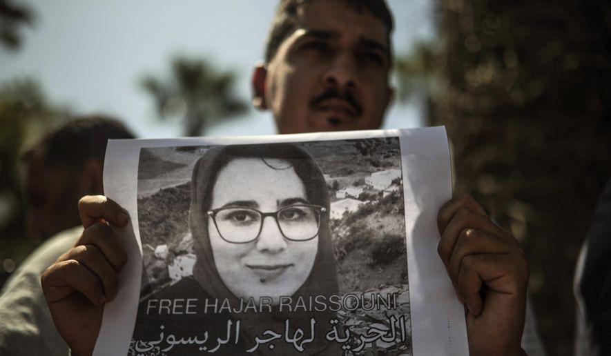 A man carries a banner at a demonstration outside a court in solidarity with detained journalist Hajar Raissouni, in Rabat, Morocco, Monday, Sept. 9, 2019. Banner in Arabic reads "Freedom to Hajar Raissouni" (AP Photo/Mosa'ab Elshamy)