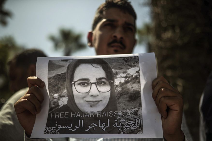 A man carries a banner at a demonstration outside a court in solidarity with detained journalist Hajar Raissouni, in Rabat, Morocco, Monday, Sept. 9, 2019. Banner in Arabic reads "Freedom to Hajar Raissouni" (AP Photo/Mosa'ab Elshamy)