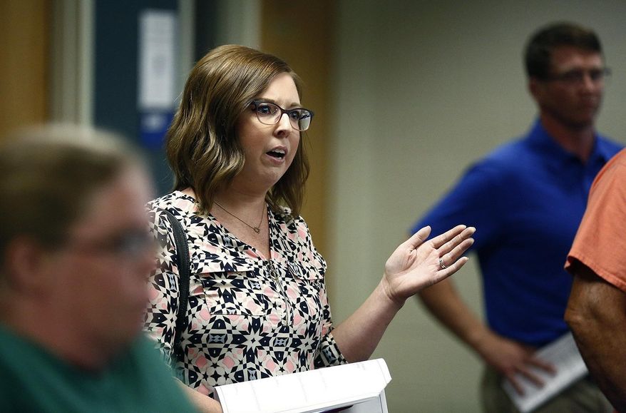 In this Aug. 22, 2019, file photo, Monica Davis, parent of an elementary school student, expresses her displeasure at a meeting at Highland High School in Marengo, Ohio, about how the school board handled a recent incident where a child had access to a gun, pointed it at another student, and that parents weren't informed. Schools across the country have faced a backlash for favoring privacy over telling parents when there are threats in their children’s classrooms. Safety experts advise schools to tell parents as much as they can as soon as they can about threats. (Fred Squillante/The Columbus Dispatch via AP)