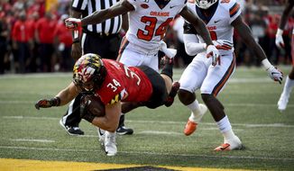 Maryland running back Jake Funk (34) dives for a touchdown in front of Syracuse defensive back Eric Coley (34) during the second half of an NCAA college football game, Saturday, Sept. 7, 2019, in College Park, Md. (AP Photo/Will Newton) ** FILE **