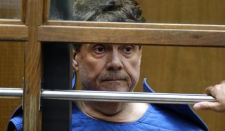 FILE - In this July 1, 2019, file photo, Dr. George Tyndall, 72, listens during an arraignment at Los Angeles Superior court in Los Angeles. Tyndall, a former University of Southern California gynecologist charged with sexually assaulting patients, has surrendered his state medical license. The Medical Board of California says George Tyndall gave up his license effective last Thursday, Sept. 5, 2019. (AP Photo/Richard Vogel, File)