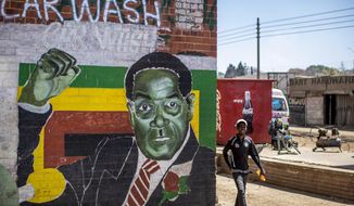 A man walks past a mural of former president Robert Mugabe, in the low income neighbourhood of Mbare, known to have many supporters of Mugabe&#x27;s ZANU-PF party, in the capital Harare, Zimbabwe Monday, Sept. 9, 2019. Mugabe, who enjoyed strong backing from Zimbabwe&#x27;s people after taking over in 1980, but whose support waned following decades of repression, economic mismanagement and allegations of election-rigging, is expected to be buried on Sunday, state media reported. (AP Photo/Ben Curtis)