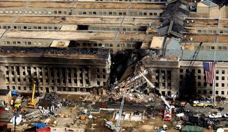 Aerial view of the Pentagon Building located in Washington, District of Columbia (DC), showing emergency crews responding to the destruction caused when a high-jacked commercial jetliner crashed into the southwest corner of the building, during the 9/11 terrorists attacks.