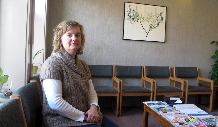 FILE - In this Feb. 20, 2013, file photo, Tammi Kromenaker, director of the Red River Valley Women's Clinic, North Dakota's sole abortion provider, sits in the waiting area of the facility in Fargo, N.D. A federal judge in North Dakota on Tuesday, Sept. 10, 2019, has blocked a state law passed earlier this year that required physicians to tell women they may reverse a so-called medication abortion if they have second thoughts. Kromenaker, said the law would force doctors to give false information that is not backed up by science. (AP Photo/Dave Kolpack, File)