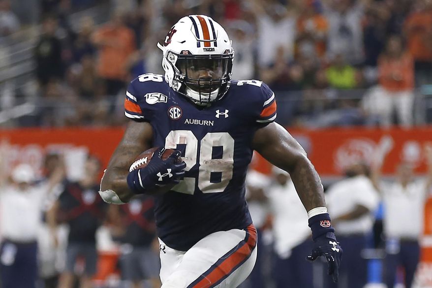 FILE - In this Aug. 31, 2019, file photo, Auburn running back JaTarvious Whitlow (28) runs against Oregon during the second half of an NCAA college football game, in Arlington, Texas. No. 8 Auburn has been leaning heavily on JaTarvious Whitlow to power a running game that's key in supporting freshman quarterback Bo Nix. (AP Photo/Ron Jenkins, File)