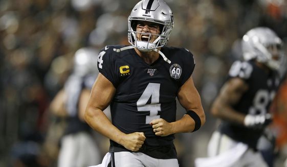 Oakland Raiders quarterback Derek Carr reacts after running back Josh Jacobs scored a touchdown during the fourth quarter of an NFL football game against the Denver Broncos Monday, Sept. 9, 2019, in Oakland, Calif. (AP Photo/D. Ross Cameron)