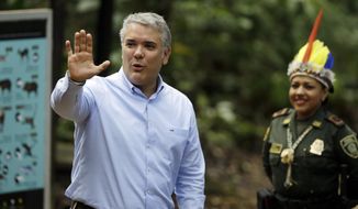 Colombia&#39;s President Ivan Duque waves upon his arrival for a meeting with leaders of several South American nations that share the Amazon, in Leticia, on Colombia&#39;s Amazon river border with Brazil and Peru, Friday, Sept. 6, 2019. Presidents and representatives from several countries in South America&#39;s Amazon region met to discuss a joint strategy for preserving the world&#39;s largest rain forest, which has been under threat from a record number of wildfires. (AP Photo/Fernando Vergara)