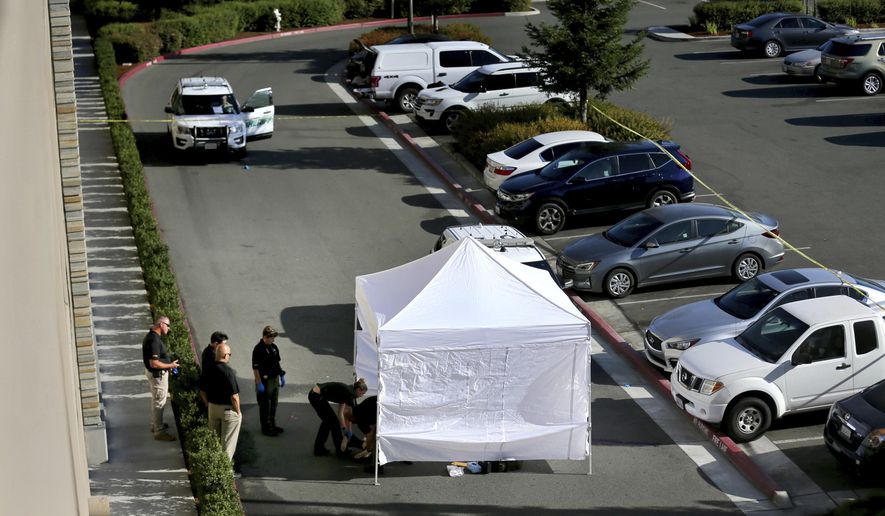 In this Monday, Sept. 9, 2019 photo, investigators from the Sonoma County Sheriff's Office examine the scene where a handcuffed man who was detained as a suicide risk broke free of deputies on the top level of a casino parking garage and jumped to his death at the Graton Resort and Casino's parking garage in Rohnert Park, Calif. The Sheriff's office says the fatal leap Monday off the five-floor garage occurred minutes after deputies had pulled the man back from the building's edge. The Press Democrat reports the man was identified as 24-year-old Geoffrey Wise Bertagnolli of Gardnerville, Nev. (Beth Schlanker/Santa Rose Press Democrat via AP)