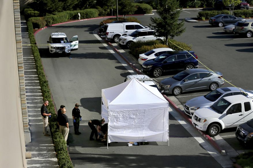 In this Monday, Sept. 9, 2019 photo, investigators from the Sonoma County Sheriff's Office examine the scene where a handcuffed man who was detained as a suicide risk broke free of deputies on the top level of a casino parking garage and jumped to his death at the Graton Resort and Casino's parking garage in Rohnert Park, Calif. The Sheriff's office says the fatal leap Monday off the five-floor garage occurred minutes after deputies had pulled the man back from the building's edge. The Press Democrat reports the man was identified as 24-year-old Geoffrey Wise Bertagnolli of Gardnerville, Nev. (Beth Schlanker/Santa Rose Press Democrat via AP)