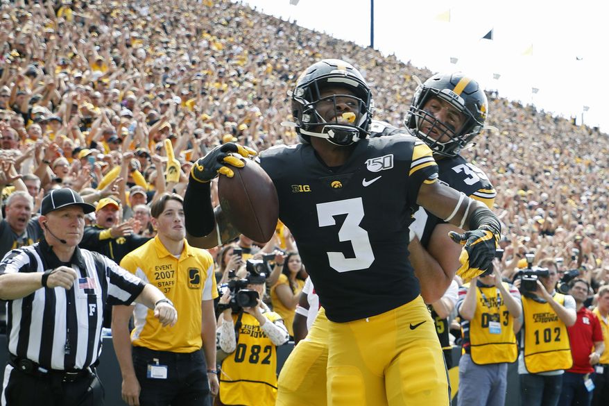 FILE - In this Sept. 7, 2019, file photo, Iowa wide receiver Tyrone Tracy, left, celebrates his touchdown reception with Iowa tight end Nate Wieting, right, during the first half of an NCAA college football game against Rutgers, in Iowa City. No. 19 Iowa's passing game has been lethal so far _ despite losing two first-round picks in tight ends T.J. Hockenson and Noah Fant.(AP Photo/Matthew Putney, File)