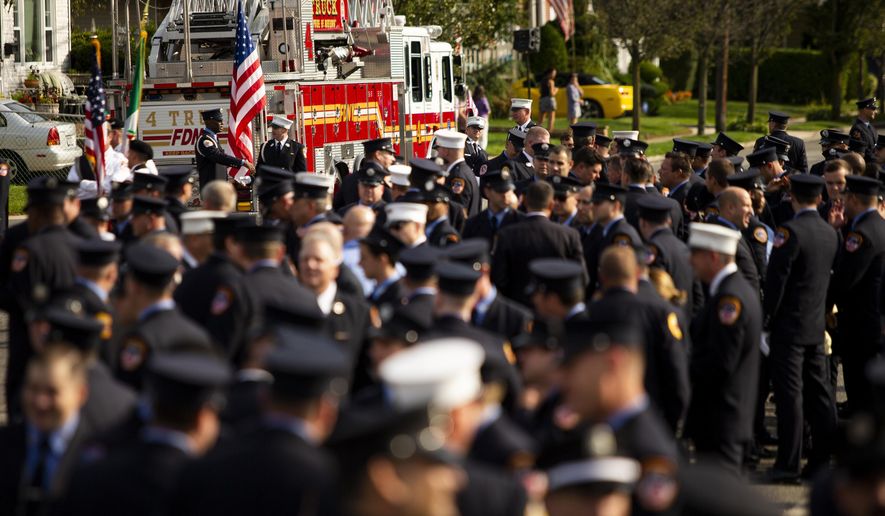 New York Fire Department members attend second funeral service for FDNY firefighter Michael Haub in Franklin Square, N.Y., Tuesday, Sept. 10, 2019. The firefighter from Long Island who died in the World Trade Center attacks is being remembered for a second time on the eve of the 18th anniversary of 9/11. (AP Photo/Eduardo Munoz Alvarez)