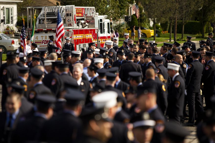 New York Fire Department members attend second funeral service for FDNY firefighter Michael Haub in Franklin Square, N.Y., Tuesday, Sept. 10, 2019. The firefighter from Long Island who died in the World Trade Center attacks is being remembered for a second time on the eve of the 18th anniversary of 9/11. (AP Photo/Eduardo Munoz Alvarez)
