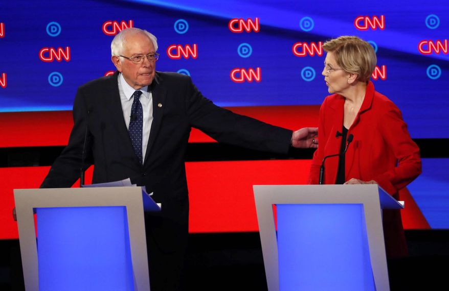 Part of a "liberal sandwich"? Sen. Bernard Sanders and Sen. Elizabeth Warren share a moment at a Democratic presidential debate in Detroit. (Associated Press)