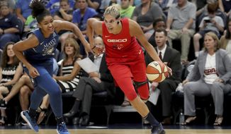 FILE - In this Aug. 16, 2019, file photo, Washington Mystics&#39; Elena Delle Donne drives against Minnesota Lynx&#39;s Damiris Dantas (92) during a WNBA basketball game in Minneapolis. Delle Donne was named the Associated Press WNBA Player of the Year, Wednesday, Sept. 11, 2019. (David Joles/Star Tribune via AP, File)