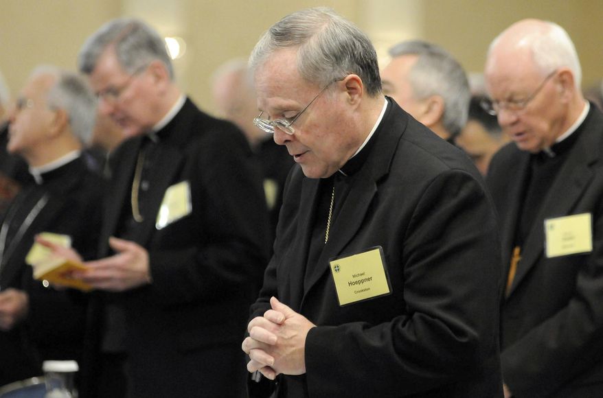 In this Nov. 10, 2008, photo, Bishop Michael Hoeppner, center, of Crookston, Minn., prays during a semi-annual meeting of the United States Conference of Catholic Bishops in Baltimore. The Roman Catholic archbishop of St. Paul and Minneapolis says he has opened an investigation under a new Vatican protocol into allegations that the bishop of Crookston interfered with investigations into clerical sexual misconduct. Archbishop Bernard Hebda made the announcement Wednesday Sept. 11, 2019. His statement says the investigation targets Bishop Michael Hoeppner of the Crookston diocese in northwestern Minnesota. (AP Photo/ Steve Ruark) **FILE**