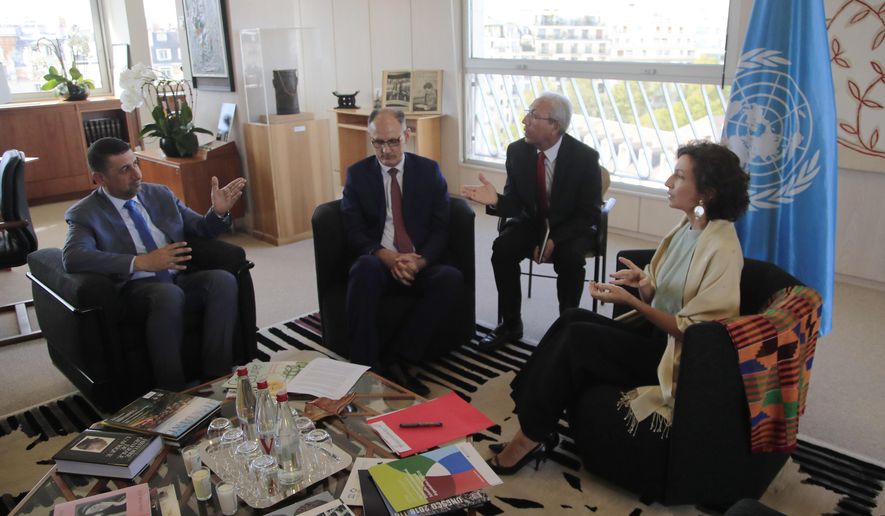 Governor of the province Nineveh Mansour al-Mareed, left, and Iraq's Culture Minister Abdulamir al-Dafar Hamdani, center, meet UNESCO'S Director-General Audrey Azoulay at the UNESCO's headquarters in Paris, Wednesday, Sept. 11. 2019. Iraqi officials meet at the UN's cultural agency in Paris to discuss plans for an ambitious $100 million reconstruction of the Islamic State-ravaged city of Mosul. (AP Photo/Michel Euler)