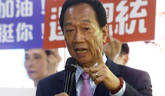 FILE - In this June 21, 2019, file photo, Terry Gou, chairman of Foxconn, the world&#39;s largest contract assembler of consumer electronics, speaks to the media after the company&#39;s annual shareholders meeting in New Taipei City, Taiwan. Gou, who is considering a run for the presidency, met with former legislative leader Wang Jin-pyng. Gou has until Tuesday to decide. (AP Photo/Chiang Ying-ying, File)