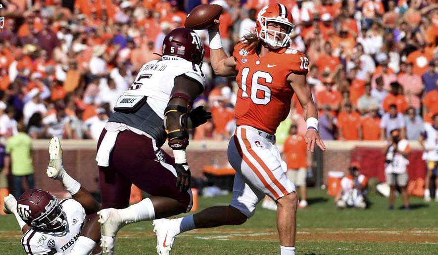 Clemson quarterback Trevor Lawrence (16) passes while pressured by Texas A&M's Bobby Brown during the first half of an NCAA college football game Saturday, Sept. 7, 2019, in Clemson, S.C. (AP Photo/Richard Shiro)