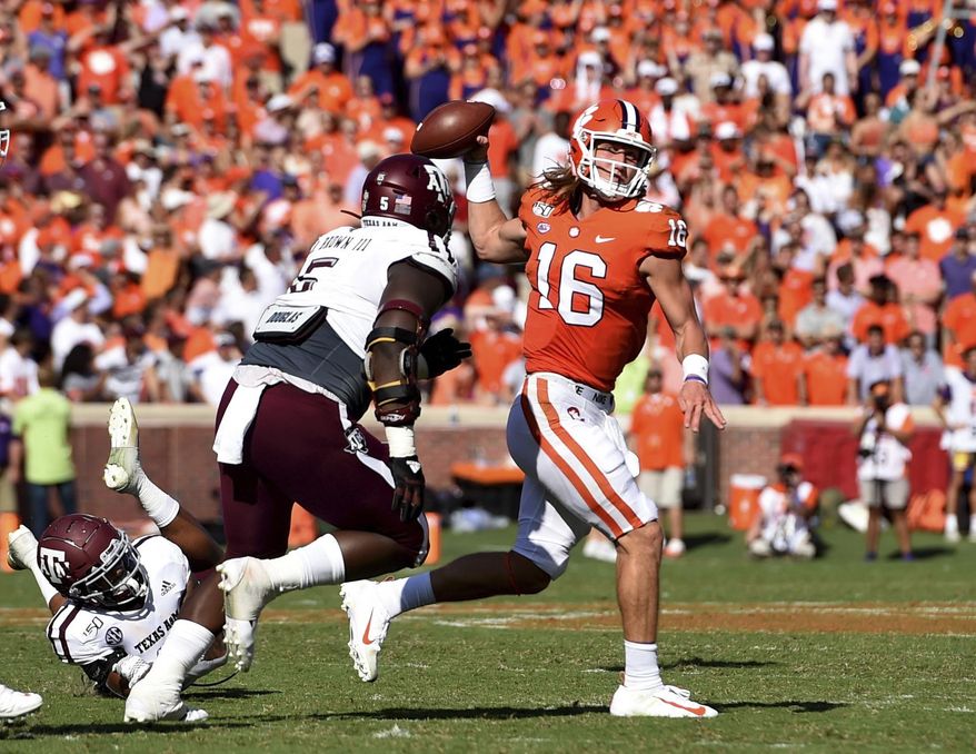 Clemson quarterback Trevor Lawrence (16) passes while pressured by Texas A&M's Bobby Brown during the first half of an NCAA college football game Saturday, Sept. 7, 2019, in Clemson, S.C. (AP Photo/Richard Shiro)