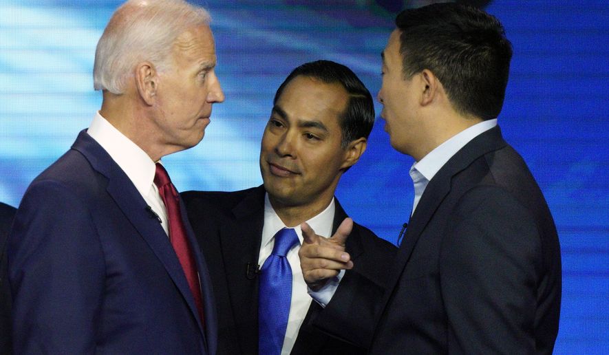 Democratic presidential candidates former Vice President Joe Biden, former Housing and Urban Development Secretary Julian Castro, and Andrew Yang talk Thursday, Sept. 12, 2019, after a Democratic presidential primary debate hosted by ABC at Texas Southern University in Houston. (AP Photo/David J. Phillip)