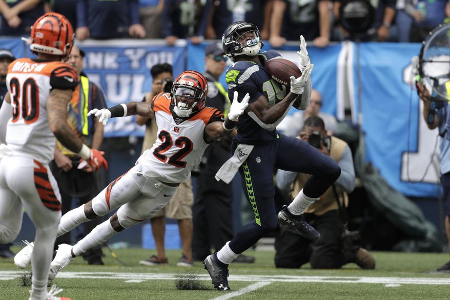 Seattle Seahawks wide receiver DK Metcalf right, makes a catch over Cincinnati Bengals cornerback William Jackson (22) during the first half of an NFL football game Sunday, Sept. 8, 2019, in Seattle. (AP Photo/Stephen Brashear)