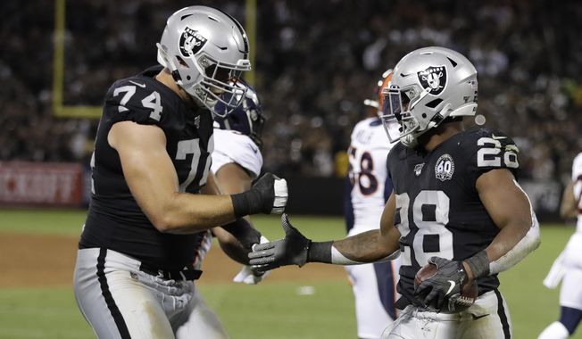 Oakland Raiders running back Josh Jacobs, right, is greeted by offensive tackle Kolton Miller (74) after scoring a touchdown during the first half of an NFL football game against the Denver Broncos Monday, Sept. 9, 2019, in Oakland, Calif. (AP Photo/Ben Margot)