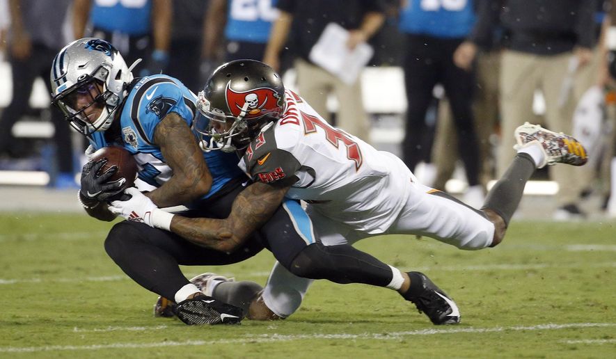 Carolina Panthers wide receiver D.J. Moore (12) is tackled by Tampa Bay Buccaneers cornerback Carlton Davis (33) during the first half of an NFL football game in Charlotte, N.C., Thursday, Sept. 12, 2019. (AP Photo/Brian Blanco)