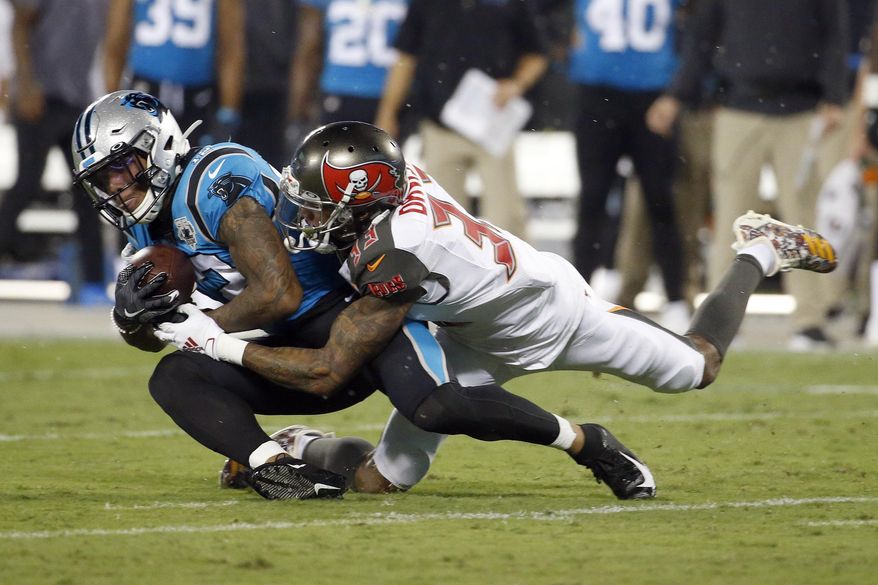 Carolina Panthers wide receiver D.J. Moore (12) is tackled by Tampa Bay Buccaneers cornerback Carlton Davis (33) during the first half of an NFL football game in Charlotte, N.C., Thursday, Sept. 12, 2019. (AP Photo/Brian Blanco)