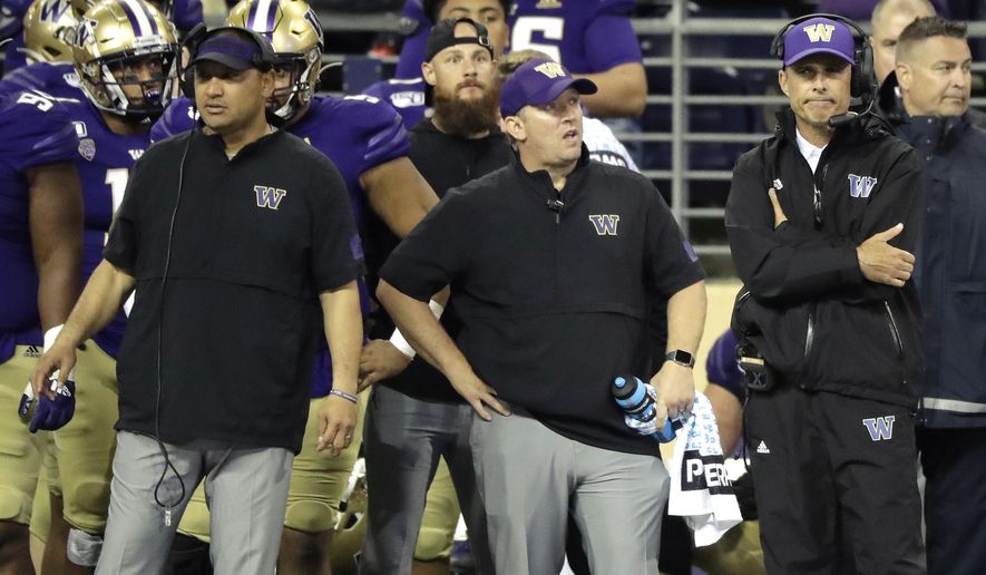 Washington head coach Chris Petersen, right, stands with other members of his staff late in the second half of an NCAA college football game in the early hours of Sunday, Sept. 8, 2019, in Seattle. California won 20-19. (AP Photo/Ted S. Warren)