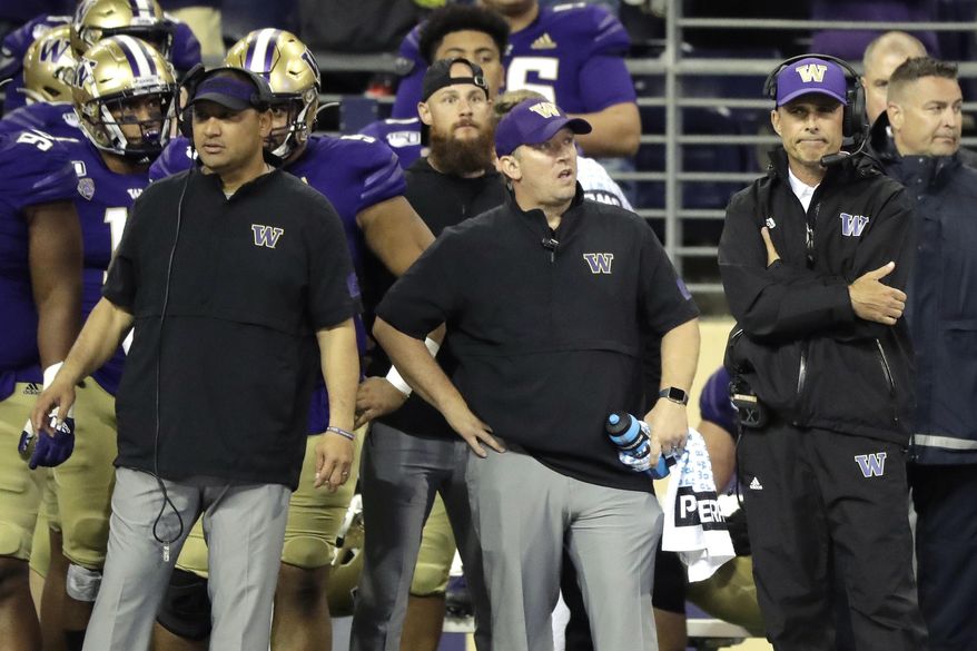 Washington head coach Chris Petersen, right, stands with other members of his staff late in the second half of an NCAA college football game in the early hours of Sunday, Sept. 8, 2019, in Seattle. California won 20-19. (AP Photo/Ted S. Warren)