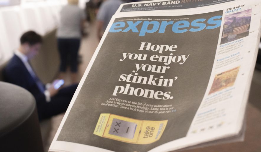 A final copy of the free commuter paper, Express, is seen at McPherson Square Metro Station in downtown Washington, Thursday, Sept. 12, 2019. The Washington Post announced yesterday that it has decided to cease publication of its Express commuter paper, that has been handed out for free at Metro stations for 16 years. (AP Photo/Pablo Martinez Monsivais)