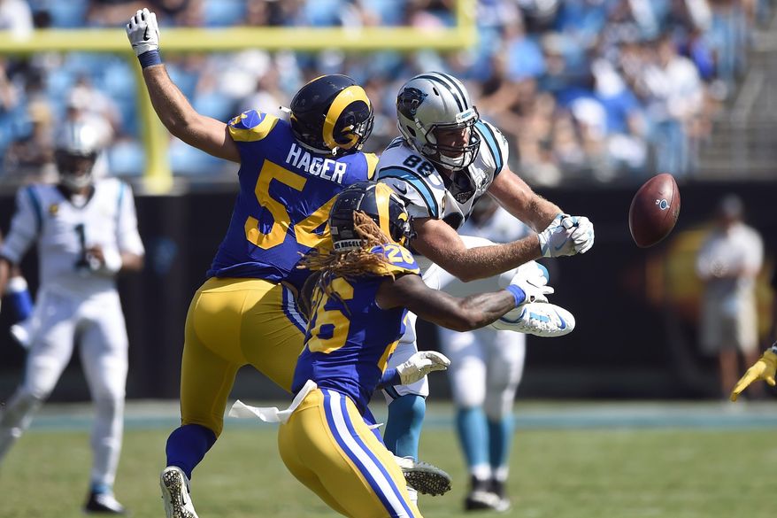 Carolina Panthers tight end Greg Olsen (88) reaches for a pass against Los Angeles Rams linebacker Bryce Hager (54) and defensive back Marqui Christian (26) during the second half of an NFL football game in Charlotte, N.C., Sunday, Sept. 8, 2019. (AP Photo/Mike McCarn)