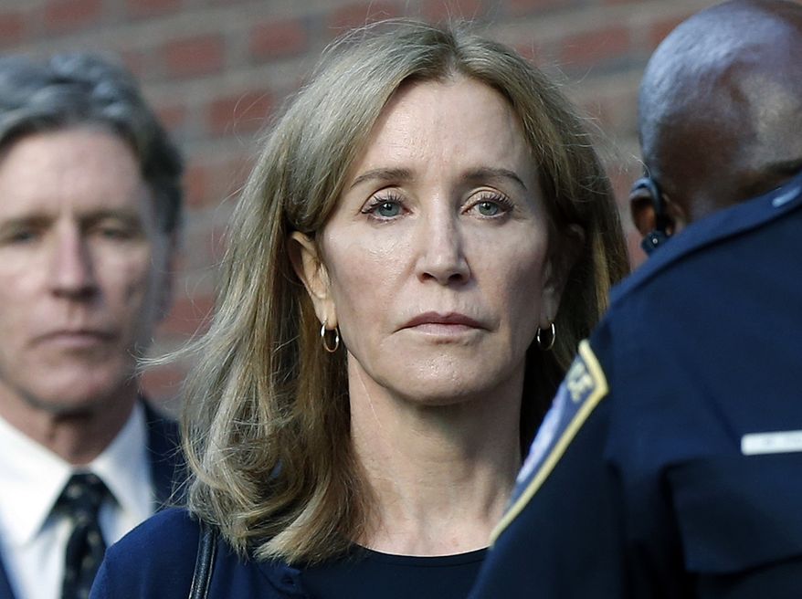 Felicity Huffman leaves federal court with her brother Moore Huffman Jr. following, after she was sentenced in a nationwide college admissions bribery scandal, Friday, Sept. 13, 2019, in Boston. (AP Photo/Michael Dwyer)