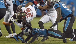 Tampa Bay Buccaneers running back Peyton Barber (25) is upended by Carolina Panthers cornerback Donte Jackson during the first half of an NFL football game in Charlotte, N.C., Thursday, Sept. 12, 2019. (AP Photo/Mike McCarn)