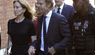 Felicity Huffman arrives at federal court with her husband William H. Macy and her brother Moore Huffman Jr., back, for sentencing in a nationwide college admissions bribery scandal, Friday, Sept. 13, 2019, in Boston.  (AP Photo/Elise Amendola)
