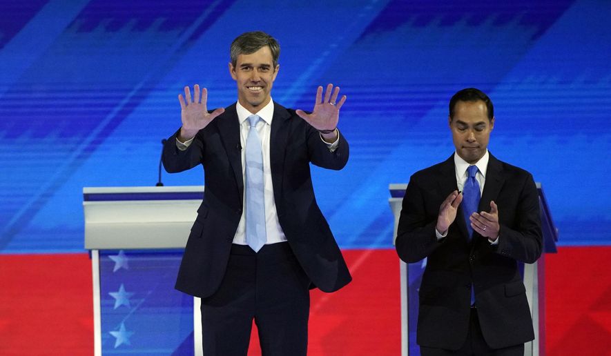 Former Texas Rep. Beto O&#39;Rourke, left, and former Housing and Urban Development Secretary Julian Castro, right, take the stage Thursday, Sept. 12, 2019, during a Democratic presidential primary debate hosted by ABC at Texas Southern University in Houston. (AP Photo/David J. Phillip)